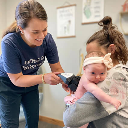 Mother and baby receiving prenatal and infant chiropractic care at Topeka's Thrive Chiropractic