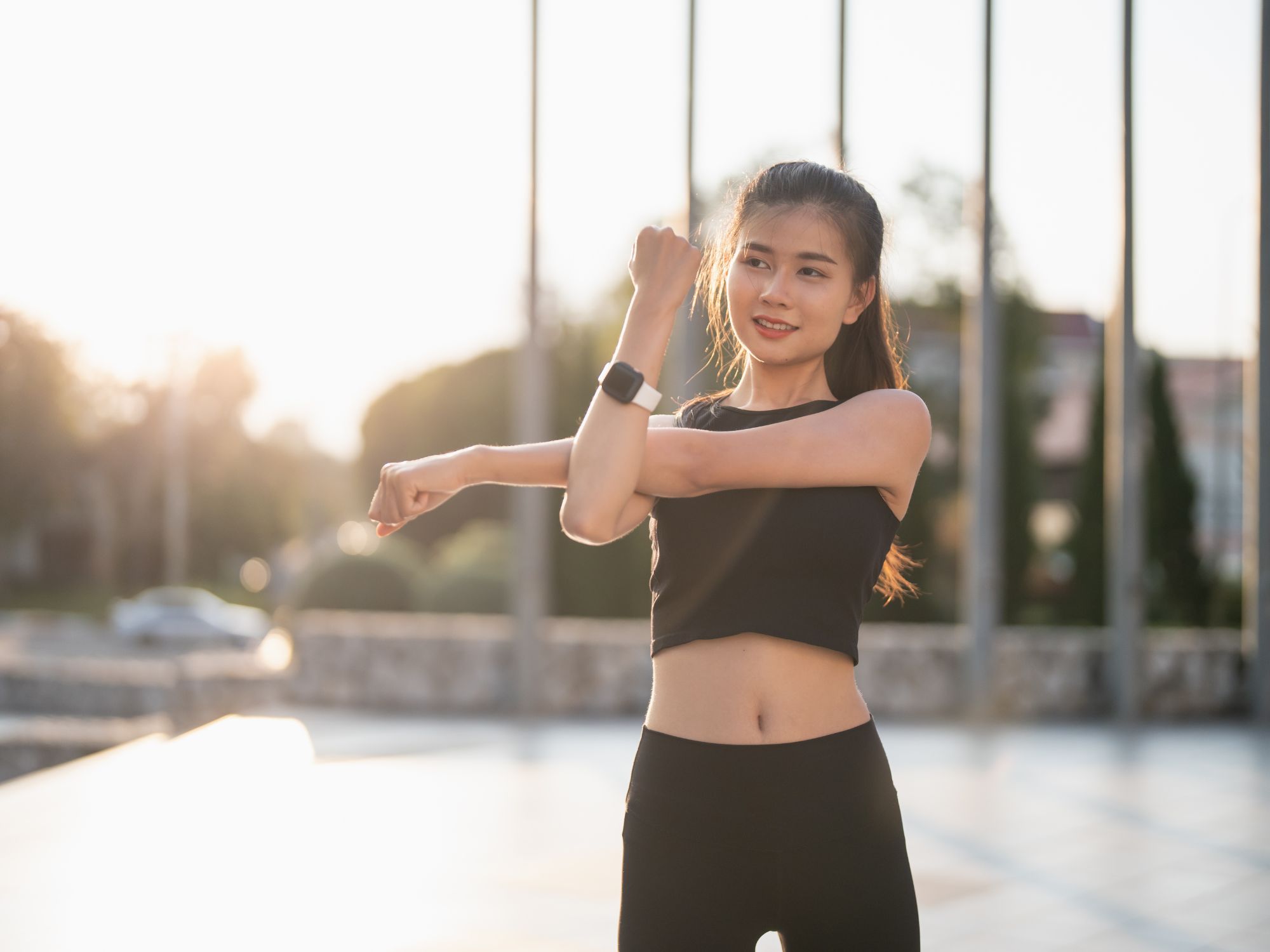 Active woman stretching outdoors - sports performance and recovery optimization through Topeka chiropractic care