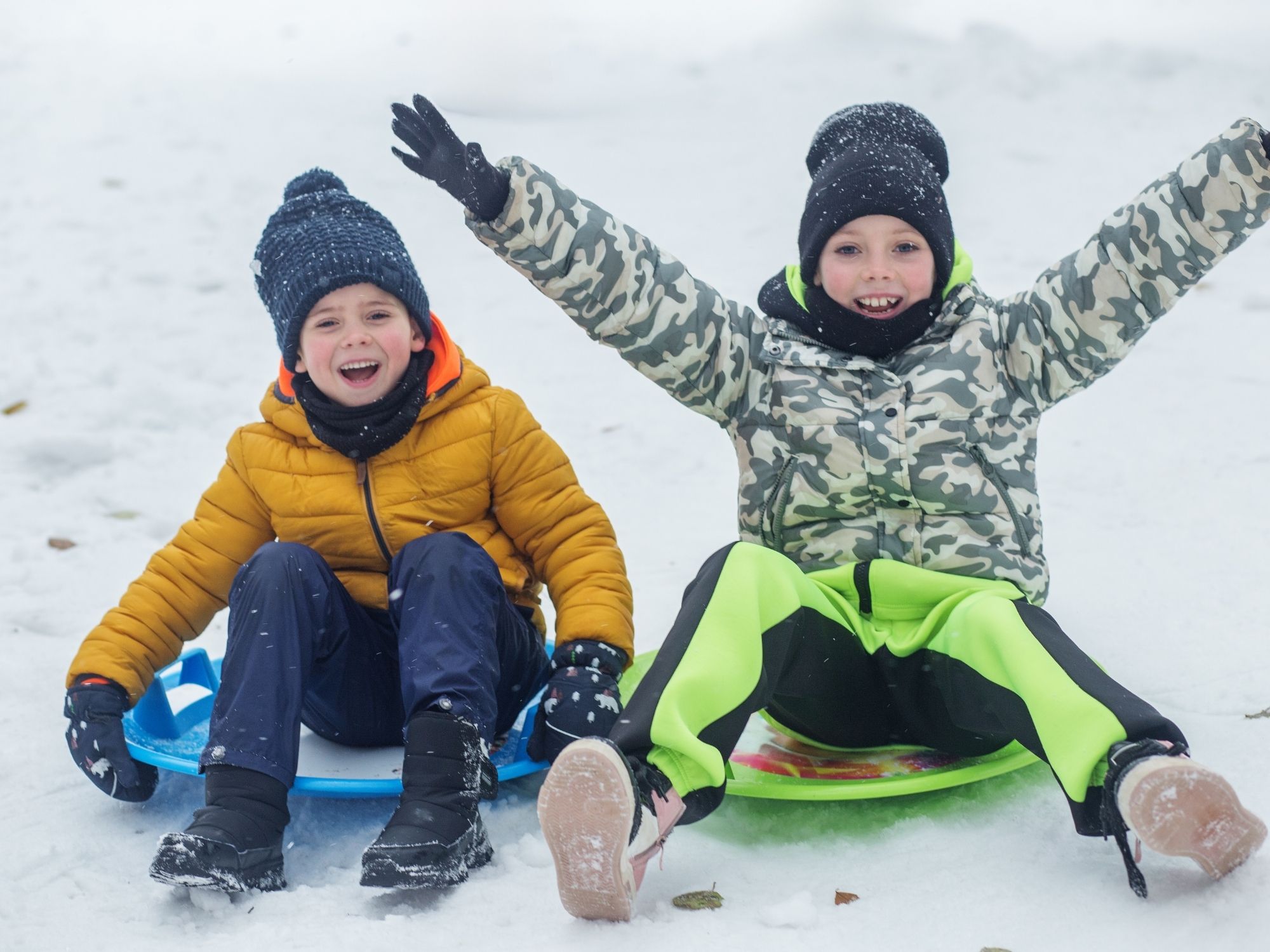 Children playing in winter snow - healthy movement patterns and coordination development at Thrive Chiropractic Topeka