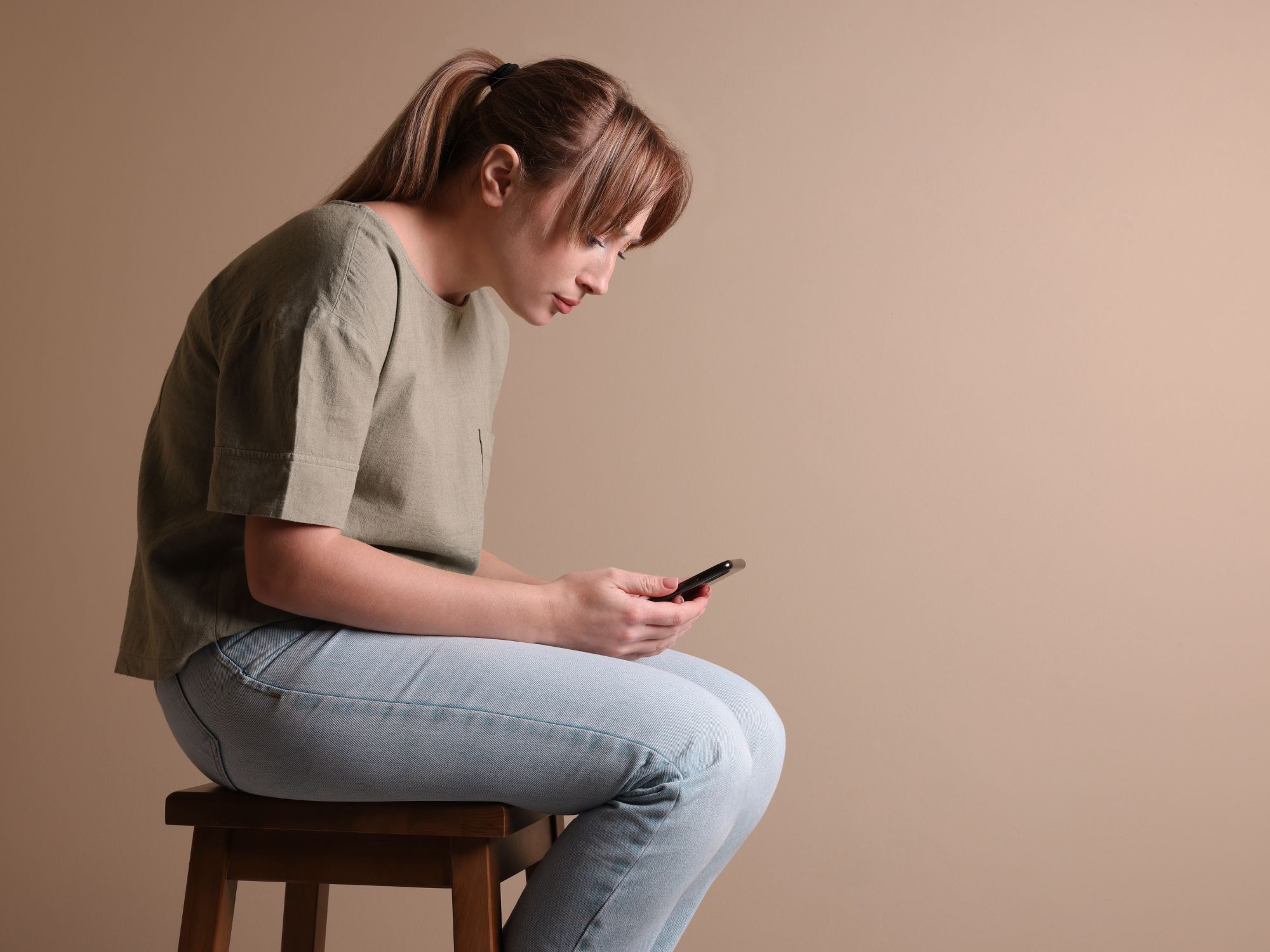 Person with forward head posture from screen use - digital age spine health care in Topeka Kansas