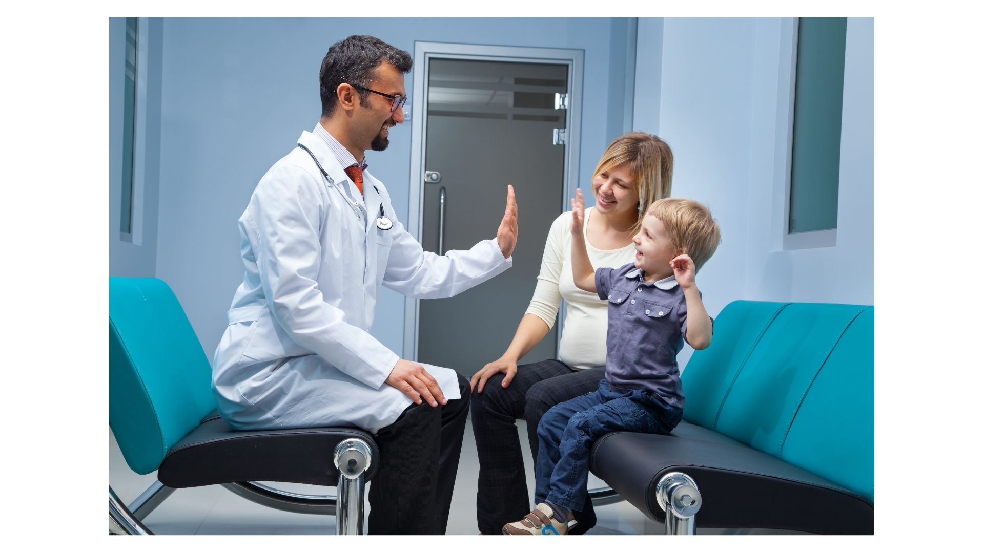 Topeka family chiropractor giving high five to young child for summer activity prep at Thrive Chiropractic
