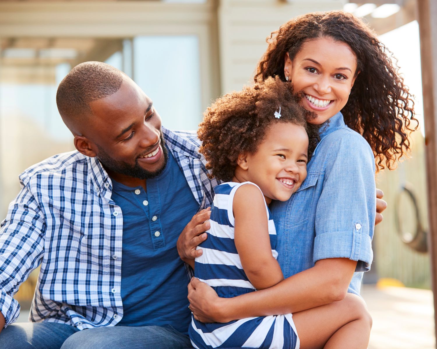 Happy Topeka family with young daughter - family-focused nervous system chiropractic care at Thrive Chiropractic